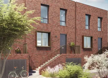 An attractive two-storey, red-brick home with a flat roof and stairs leading up to the front door.