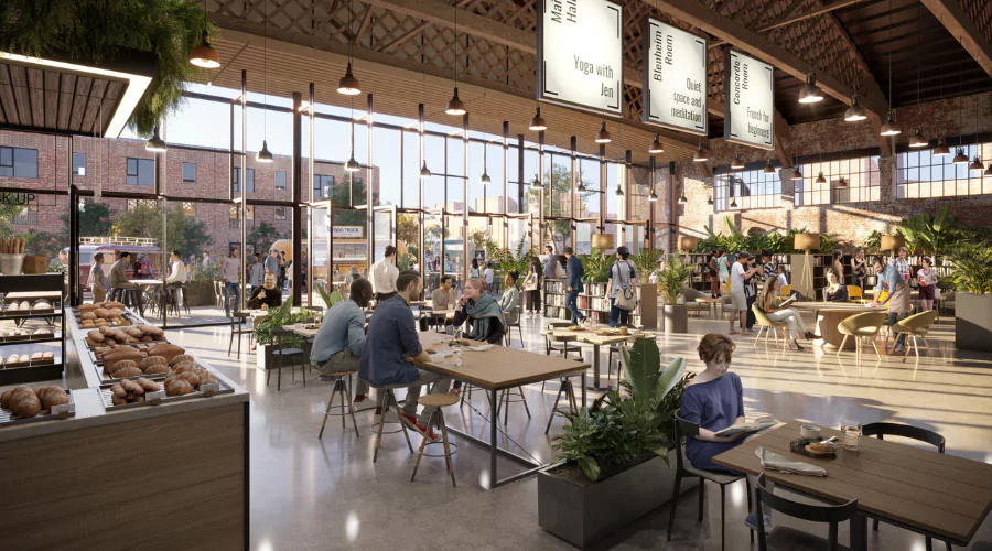 Wide angle shot of Inside Hangar 16U showing a cafe area, people using seating areas to meet and enjoy food and drink.