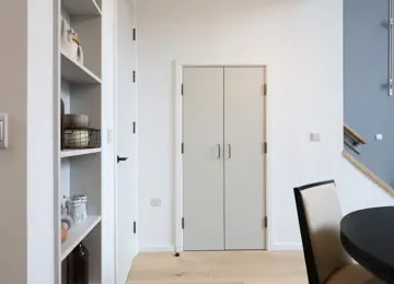 Downstairs storage cupboard within the living area.