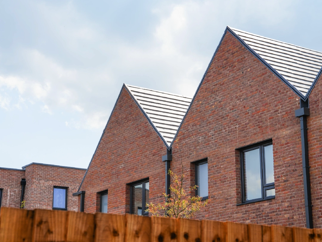 The Coanda External  Modern brick terrace house, with A-frame roofline at Brabazon, Bristol.