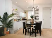 Open-plan kitchen diner with glossy white work tops, ample storage and stylish extras.
