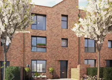 A welcoming red-brick townhome with a unique tailfin roofline and landscaped double driveway at the front.