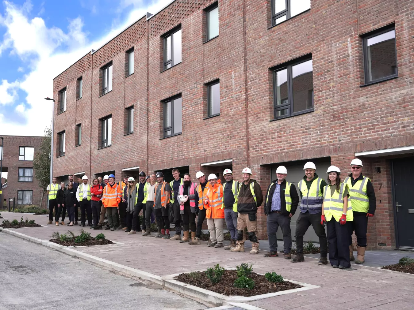 Soverign Handover At Brabazon YTL Developments, YTL Construction and SNG stand outside affordable housing on Smart Street at Brabazon in North Bristol.