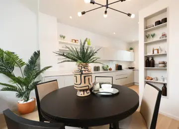 Close up of a styled diner table leading into the kitchen.