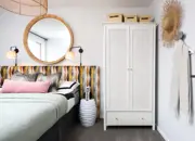 A glimpse into the double guest bedroom featuring a funky headboard, a rattan white wardrobe and stylish extras.