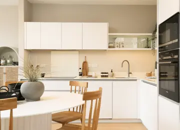 Stylish open-plan kitchen diner, featuring open shelving and integrated appliances.