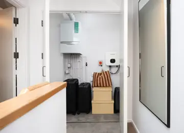 Upstairs cupboard placed within the hallway with ample storage for suitcases etc.