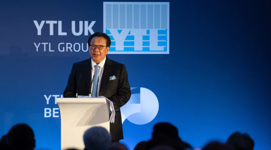 YTL Group Chairman, Tan Sri Francis Yeoh Sock Ping, presenting on stage in front of a blue YTL Group banner.