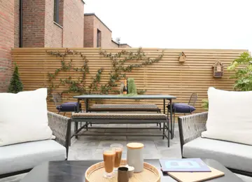 New build courtyard garden, featured slat fencing, stylish furniture and fence climbing plants.