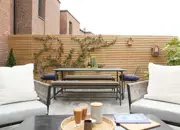 New build courtyard garden, featured slat fencing, stylish furniture and fence climbing plants.