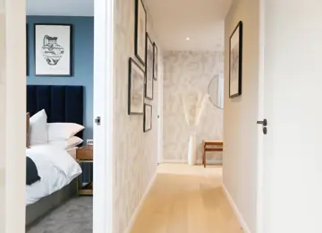 A lovely shot down the apartment hallway with a glimpse of the guest bedroom.