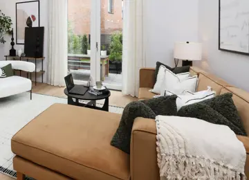 Close up of cosy furnishings on the sofa within the living area.