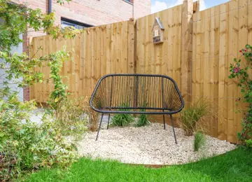 Outdoor seating area surrounded by luscious greenery.