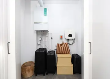 Upstairs storage cupboard placed within the hallway with ample storage.