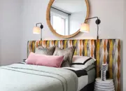A glimpse into the double guest bedroom featuring a funky headboard and stylish furnishings.