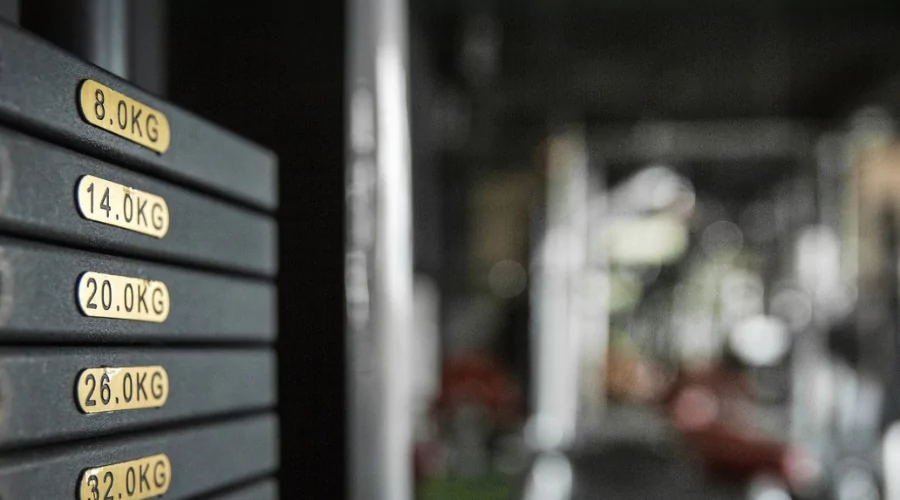 Focused shot of cable weights in a gym with blurred background.