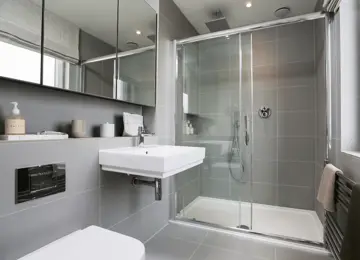 Shower room with lots of natural light, featuring a mirrored vanity unit, heated towel warmer and stylish extras.